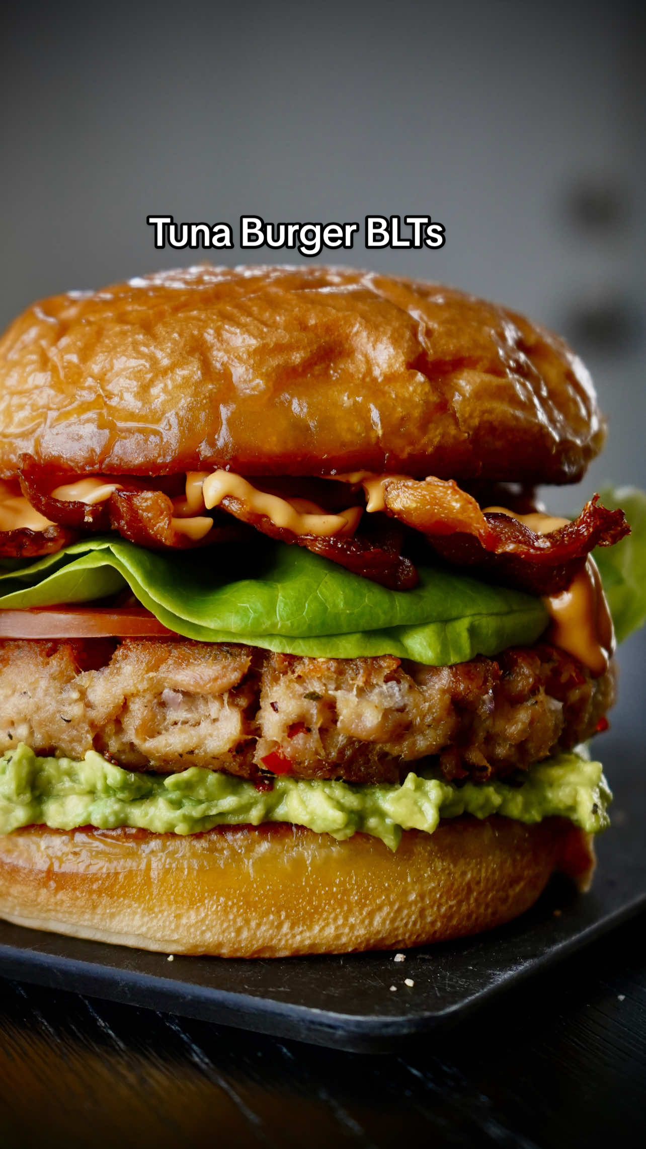 TikTok post by @calwillcookit for Safe Catch. Caption reads: Tuna Burger BLTs 🎣🥓🥬🍅  Take canned tuna to the....