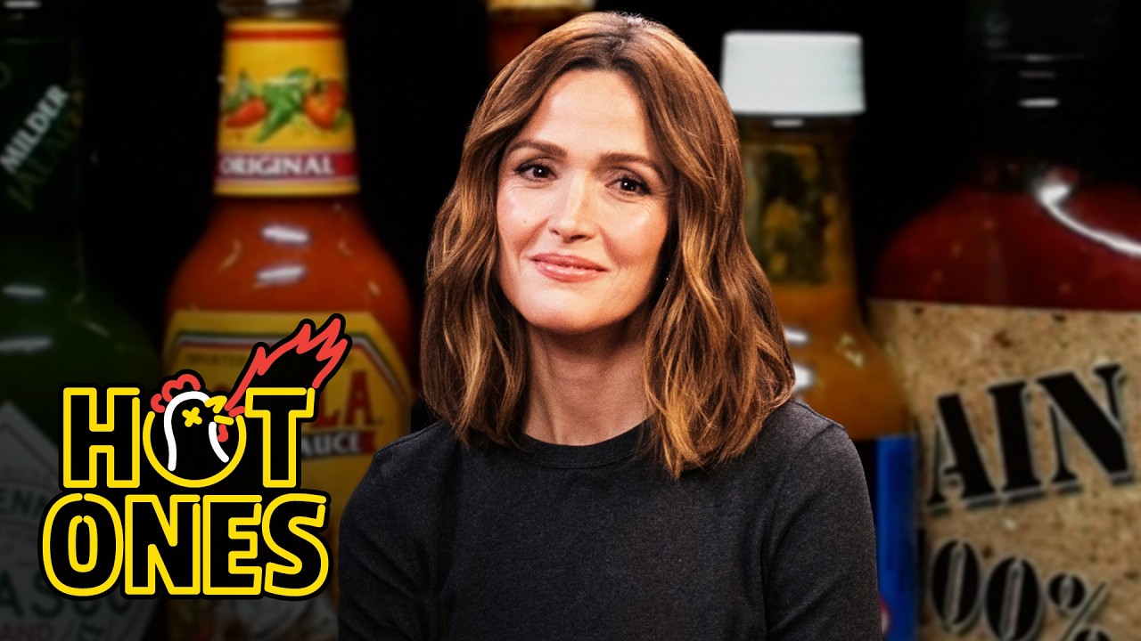 YouTube post by @FirstWeFeast for First We Feast. Caption reads: Rose Byrne Feels Crazy While Eating Spicy Wings |....