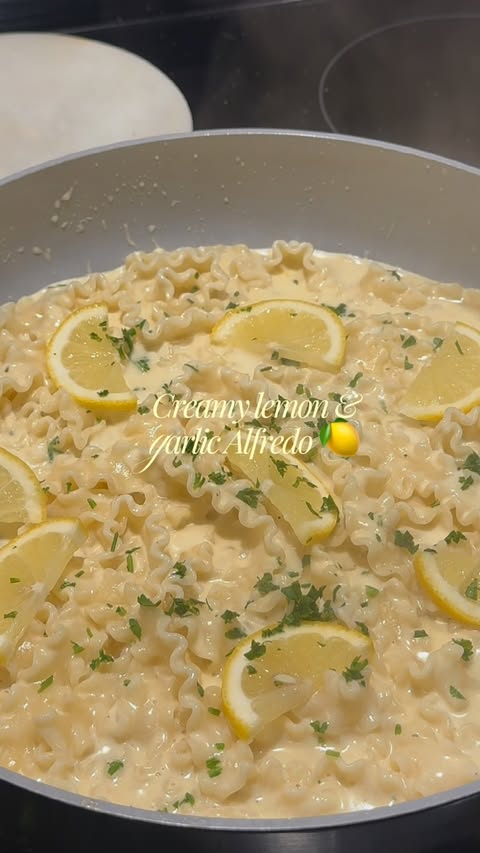 Instagram post by @simplytimaa for Caraway. Caption reads: [...] Creamy lemon garlic alfredo, made in my....