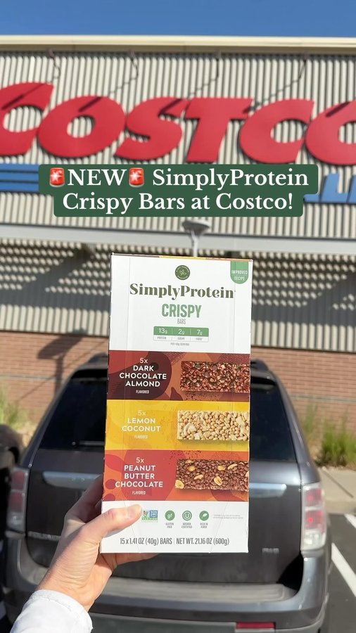 Instagram post by @costcofoodreviews for SimplyProtein. Caption reads: #ad ✨NEW & IMPROVED✨ @simplyprotein Crispy Bars at....