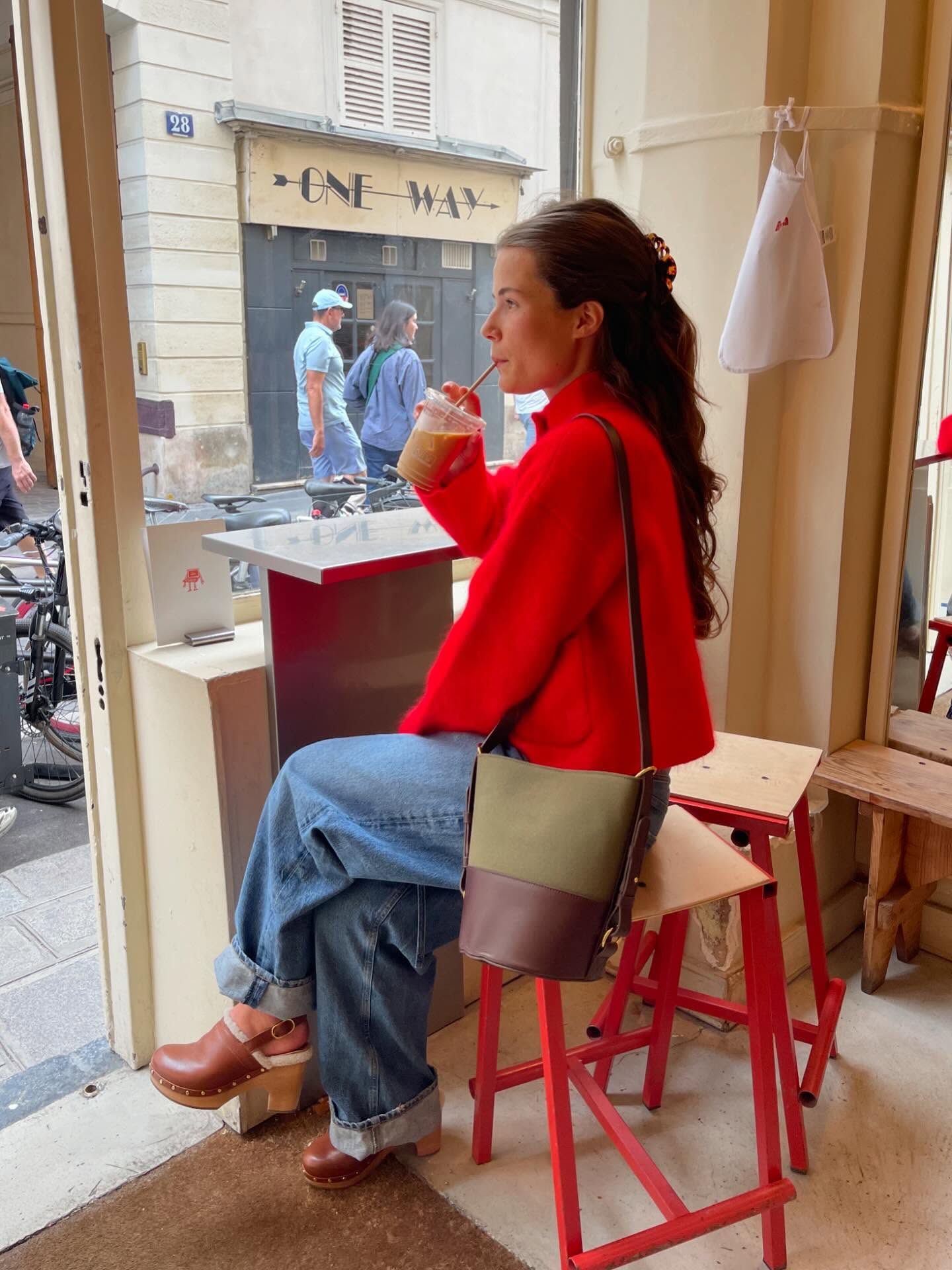 Instagram post by @manondevelder for Sezane. Caption reads: Capes, the color red, clogs & spacious leather....