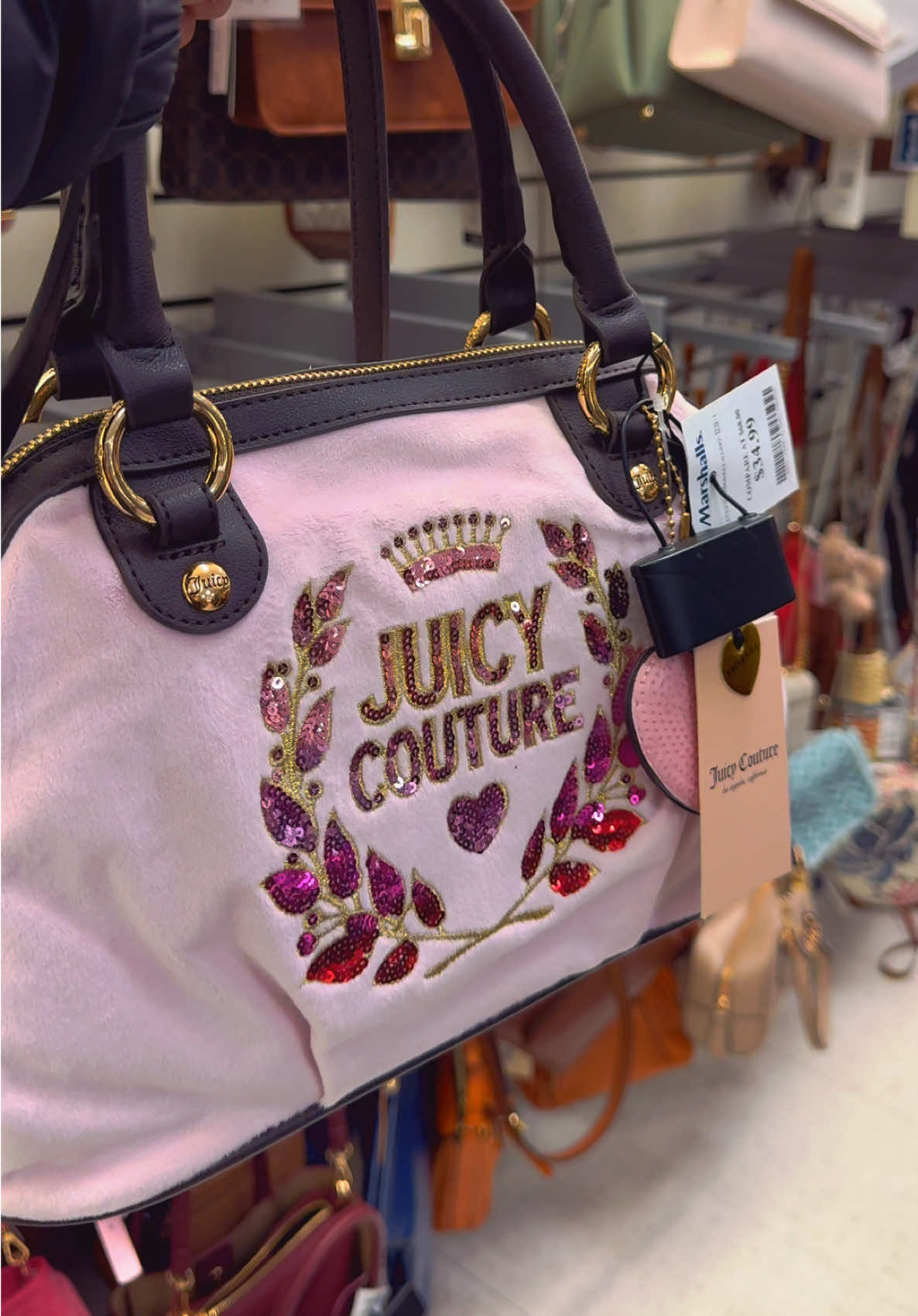 TikTok post by @amyyisabella for Juicy Couture. Caption reads: The prettiest @Juicy Couture purses found at....