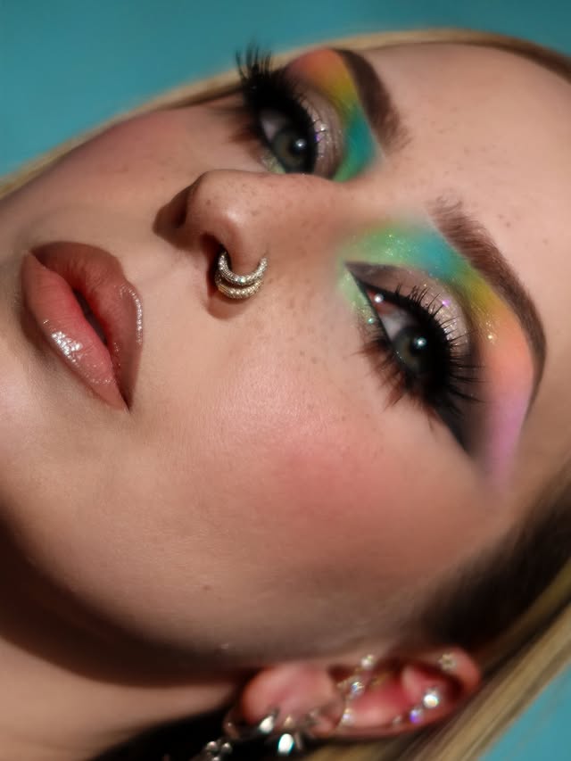 Instagram post by an influencer for essence cosmetics. Caption reads: 🩷❤️🧡💛💚🩵💙💜 @hourglasscosmetics veil mineral....