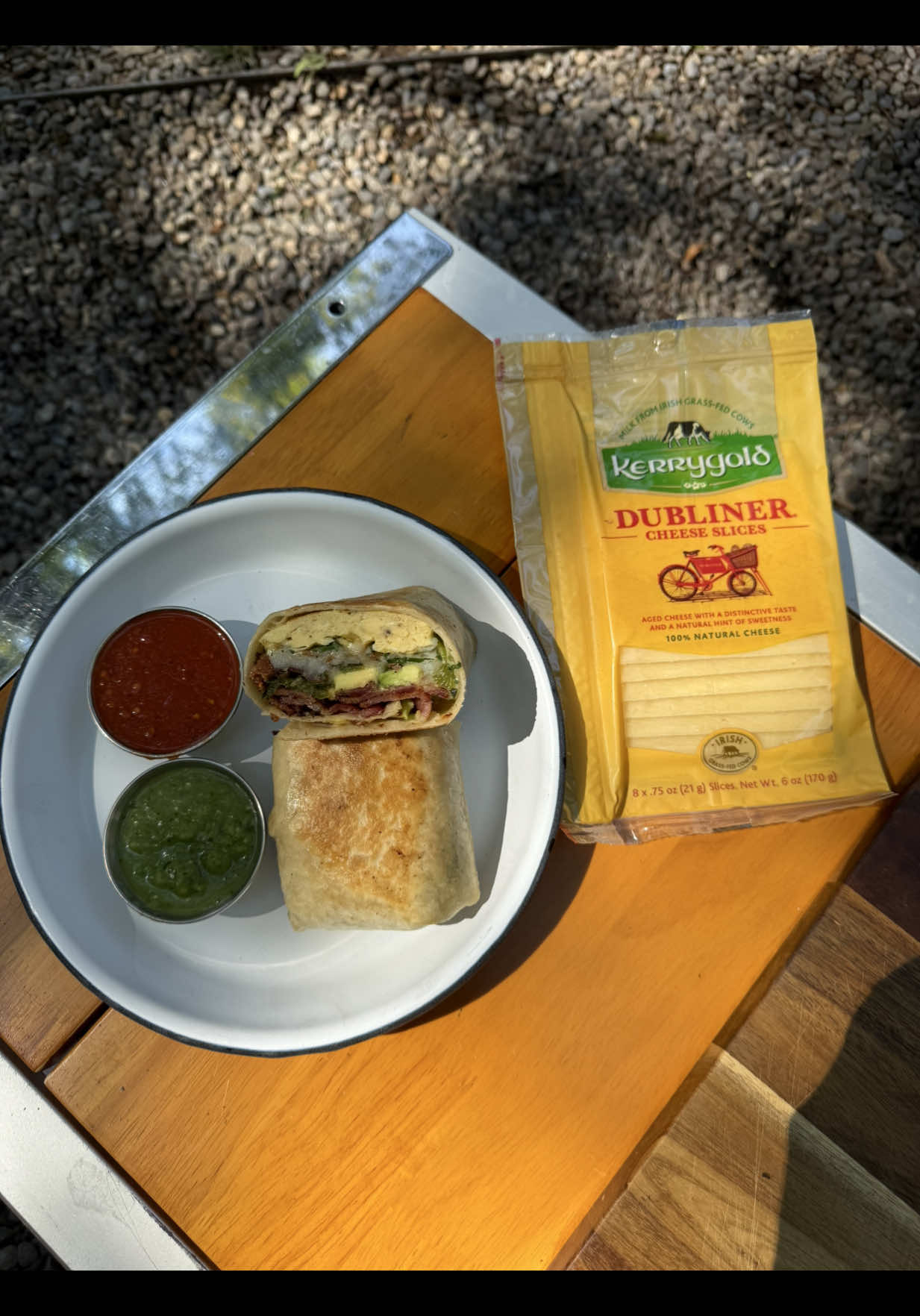 TikTok post by @haileecatalano for KerrygoldUSA. Caption reads: cheesy campfire breakfast burritos with....