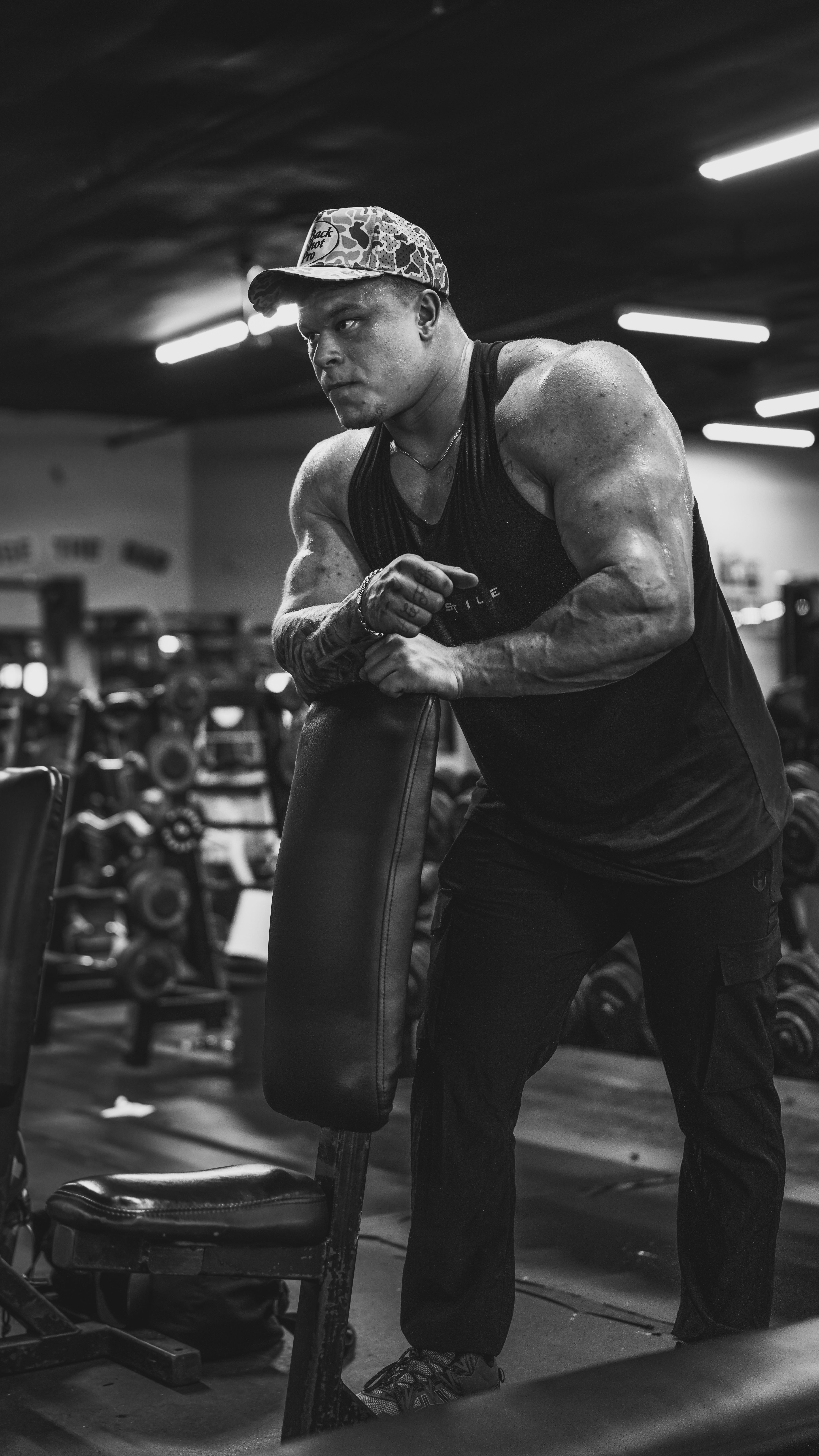 Instagram post by @_nickjustice for Hosstile. Caption reads: [...] @muscleandstrength to bring you select....