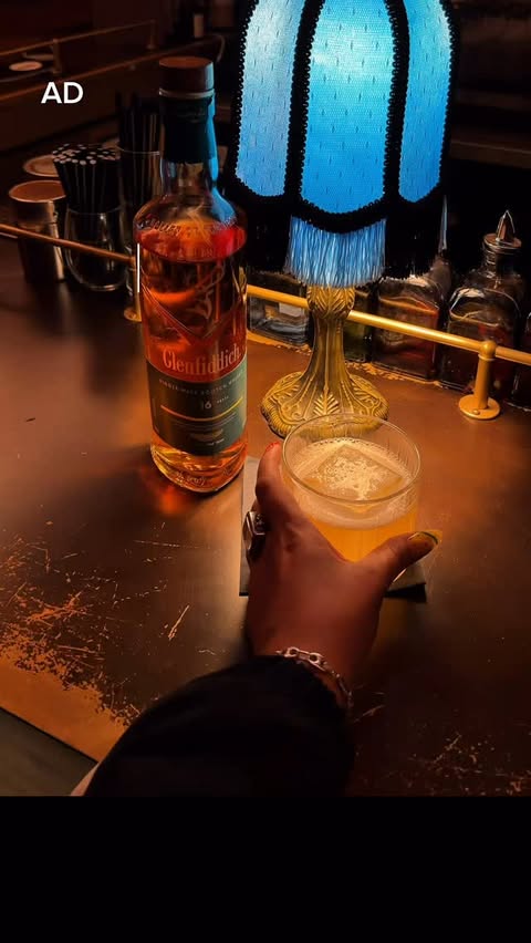 Instagram post by @thekatieromero for Glenfiddich. Caption reads: [...] 🥃 A cozy corner, good company, and a....