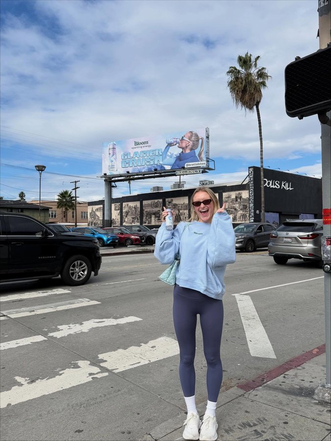 Instagram post by @brettsbites for Bloom Nutrition. Caption reads: PINCH. ME. 💙💙💙💙💙💙 @bloomsupps.