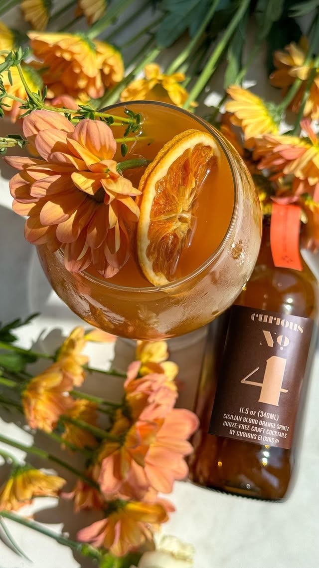 Instagram post by @champagneang for curious elixirs. Caption reads: [...] into my healthy girl era 🥂🌼 with....