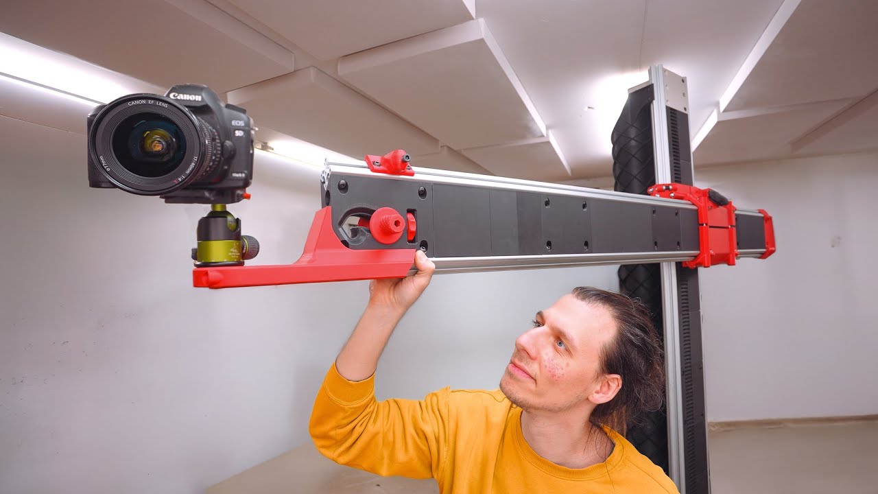 YouTube post by @achappel for Thingiverse. Caption reads: I 3D Printed a $13,238.95 Camera Arm (Again).