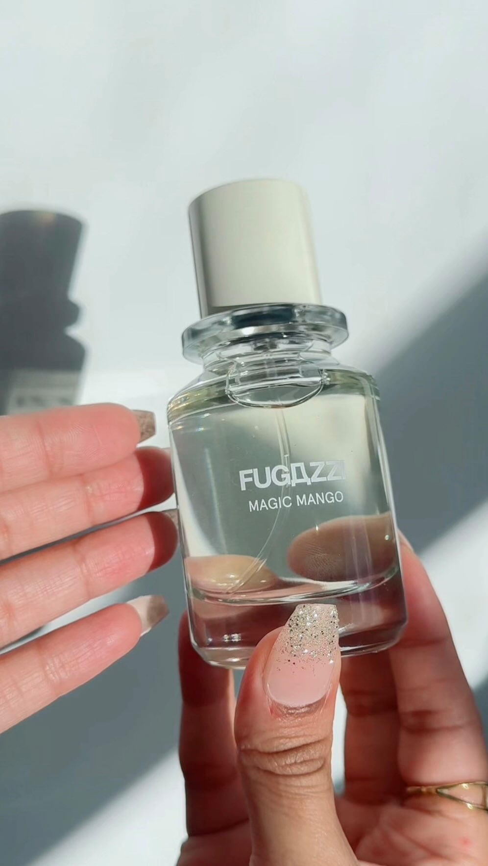Instagram post by @makeupbynoor03 for FUGAZZI Fragrances. Caption reads: Magic Mango by @fugazzifragrances takes juicy....