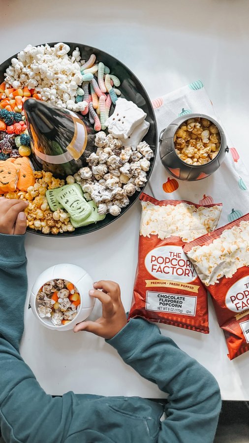 Instagram post by @mrscarr_ for The Popcorn Factory. Caption reads: I love making themed snack boards and....