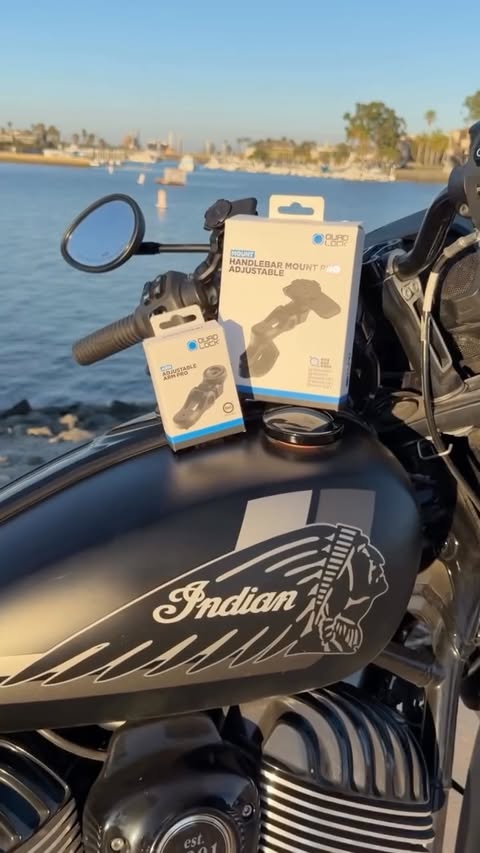 Instagram post by @carolinacoraaa for QUAD LOCK. Caption reads: Quadlock now has an adjustable Moto Mount! Check....