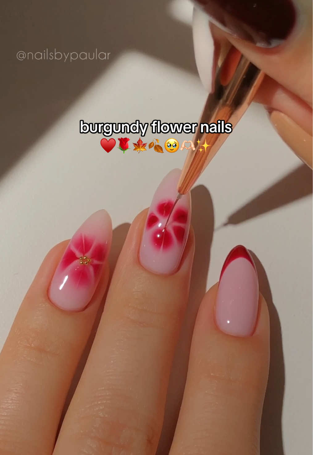 TikTok post by @nailsbypaular for MelodySusie. Caption reads: burgundy flower nails! ♥️🌹🍁 a slightly different....