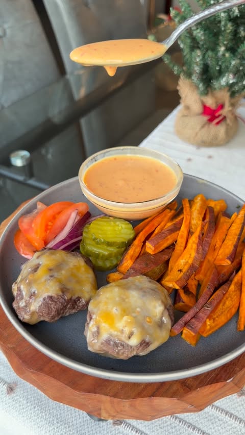 Instagram post by @mealprepsandmacros for Caraway Home. Caption reads: Sheetpan Cheeseburger & Sweet Potato Fries 🔥If....
