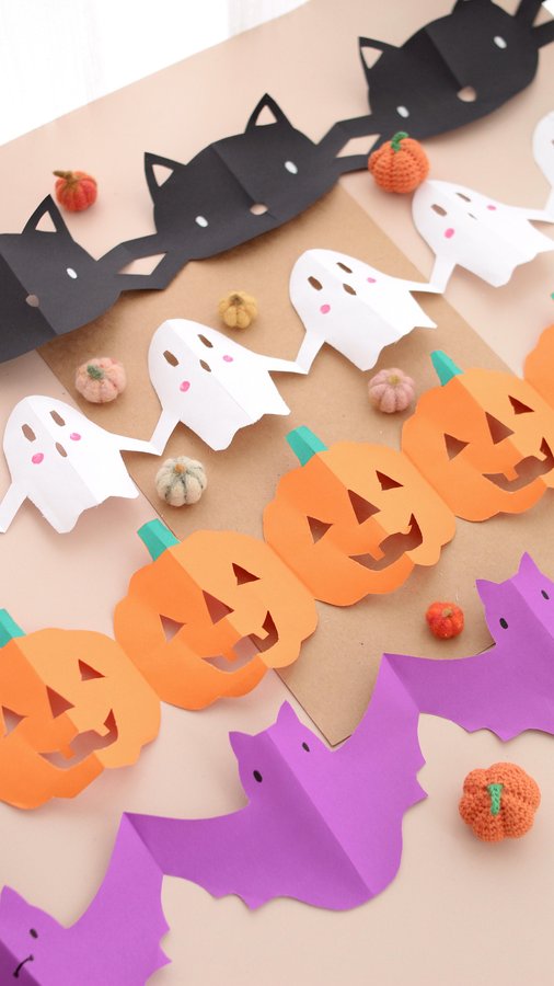 Instagram post by @mummy_and_my_three for Baker Ross. Caption reads: Easy Paper Halloween Garland Decorations using....