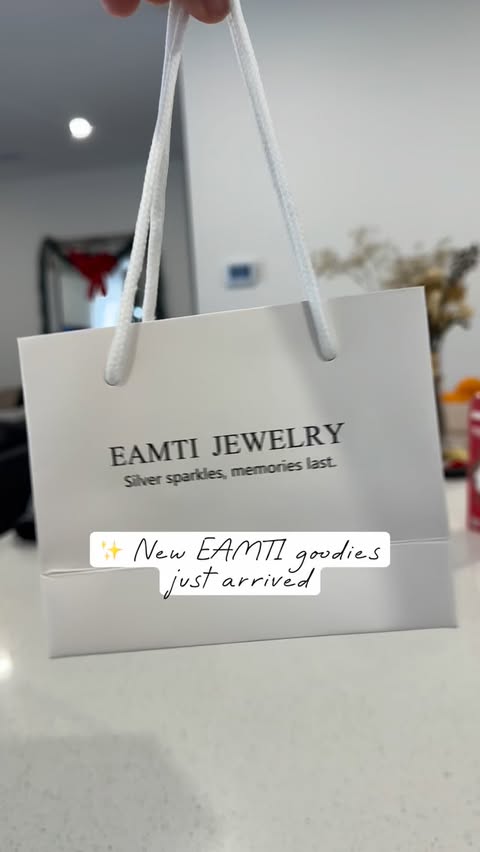 Instagram post by @holly_meza for EAMTI Jewelry. Caption reads: A little @eamtijewelry unboxing ✨
These two pieces....