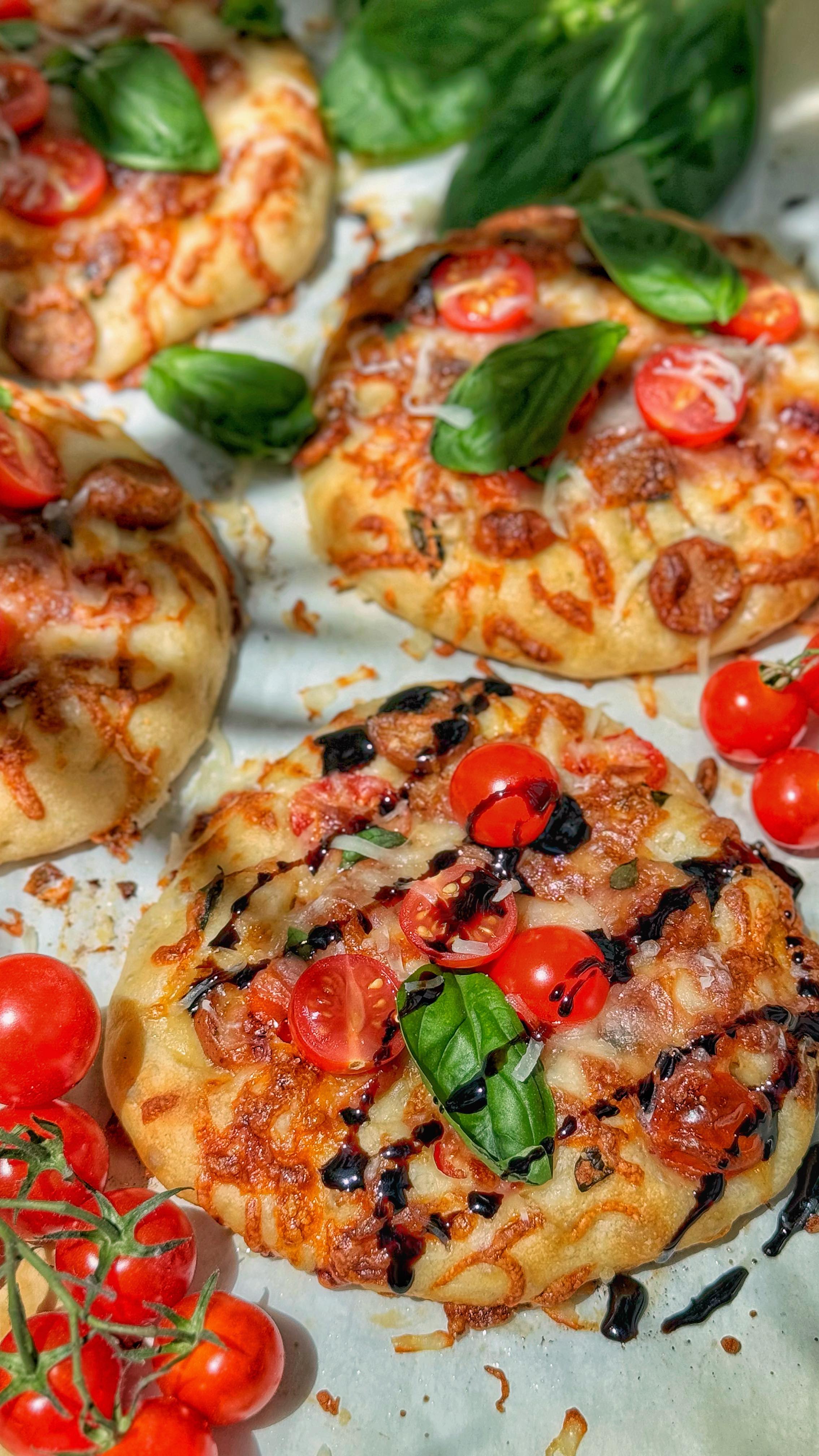 Instagram post by @granny_aye for Bake from Scratch. Caption reads: 🍅Mini Sausage Focaccia Pizza with Balsamic....