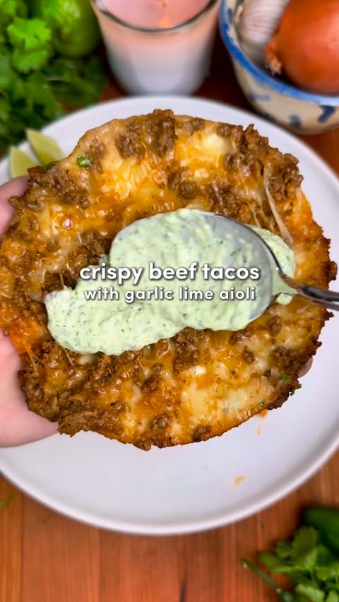 Instagram post by @recipeincaption for Primal Kitchen. Caption reads: Crispy Beef Tacos with Garlic Lime Aioli....