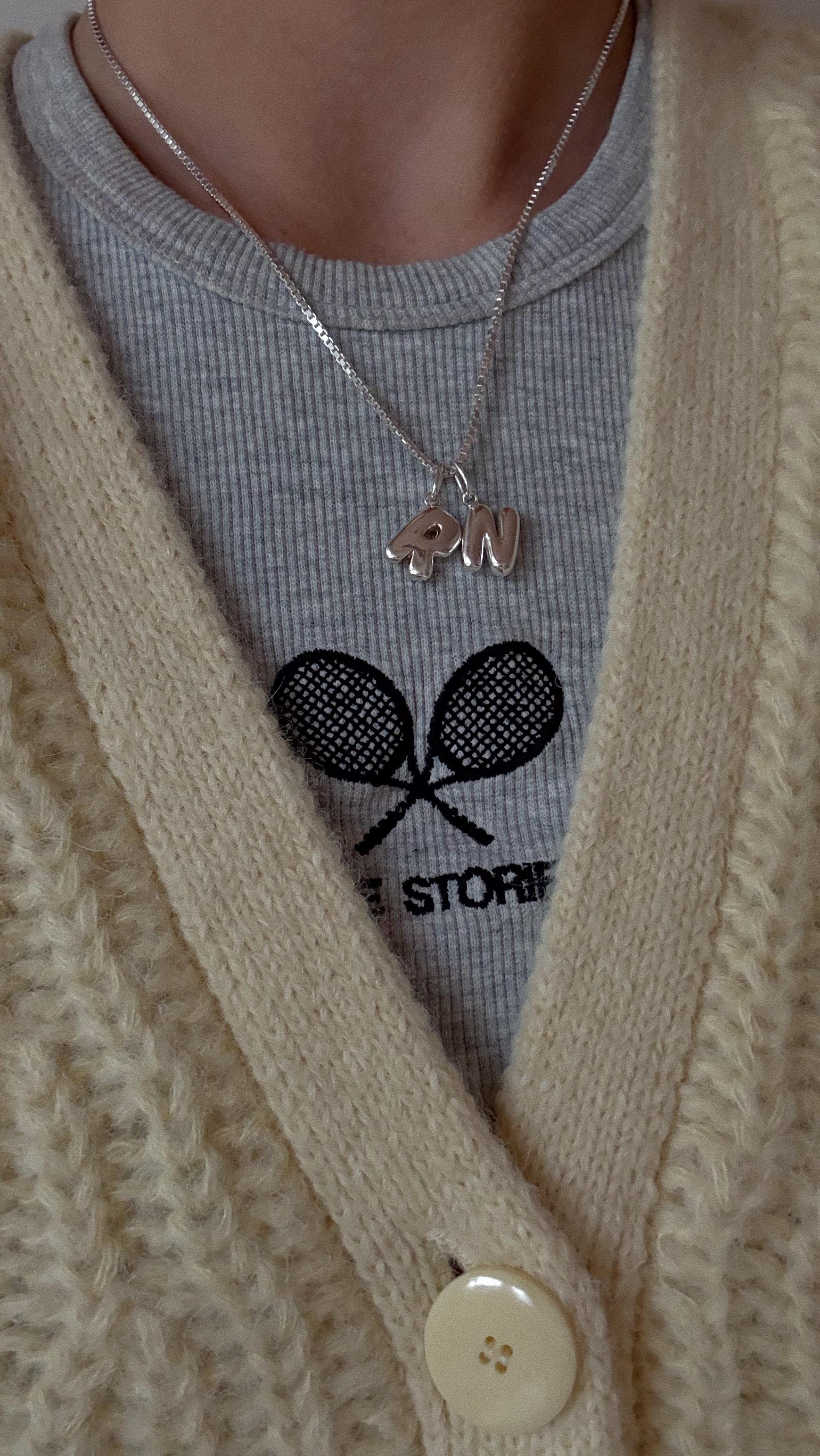 Instagram post by @friedalovesemil for Bruna The Label. Caption reads: [...] my neck: bubble letter charms /....