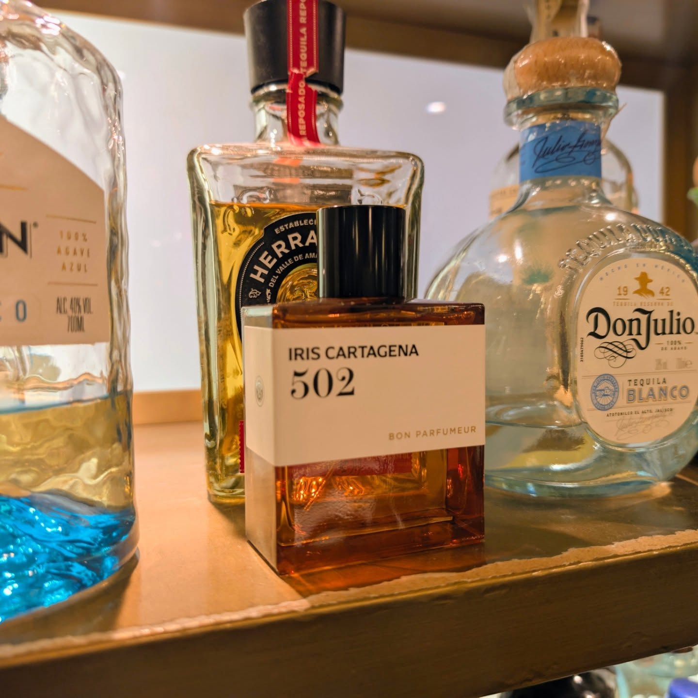 Instagram post by @omarscentstory for Bon Parfumeur. Caption reads: The bar overlooking the sea is bathed in the light....