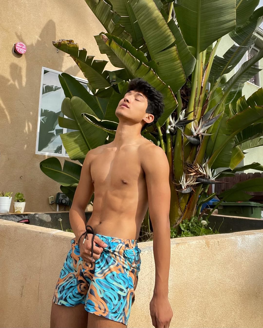 Instagram post by @glazedadrian for Icon Swim. Caption reads: catching summer during winter 😮‍💨 #ad.
