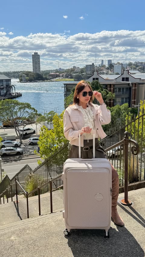 Instagram post by @our_unpredictable_journey for American Tourister. Caption reads: [...] all 💼 I was challenged to put my American....