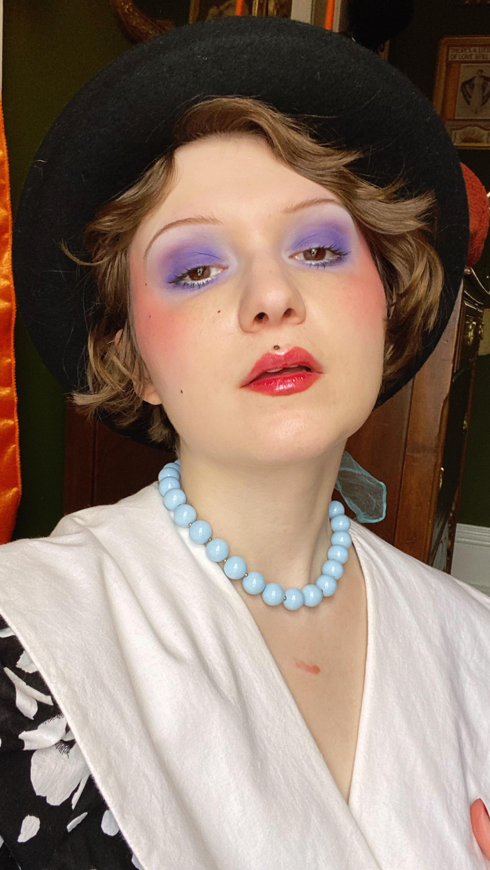 Instagram post by @amberortolano for Kaleidos Makeup. Caption reads: work grwm 80s edition! 🕺

eyeshadow palette is....