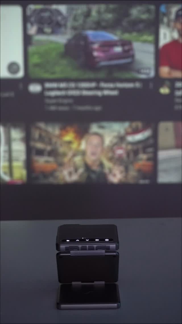 Instagram post by @luksetups for Aurzen. Caption reads: 🎥 Aurzen ZIP Tri-Fold Ultra Portable Projector —....