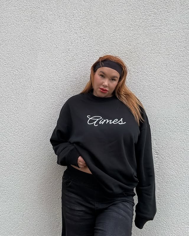 Instagram post by @amywhitfield_official for Streetshirts. Caption reads: 🤍🖤 @streetshirtscom #streetshirts #collaboration....