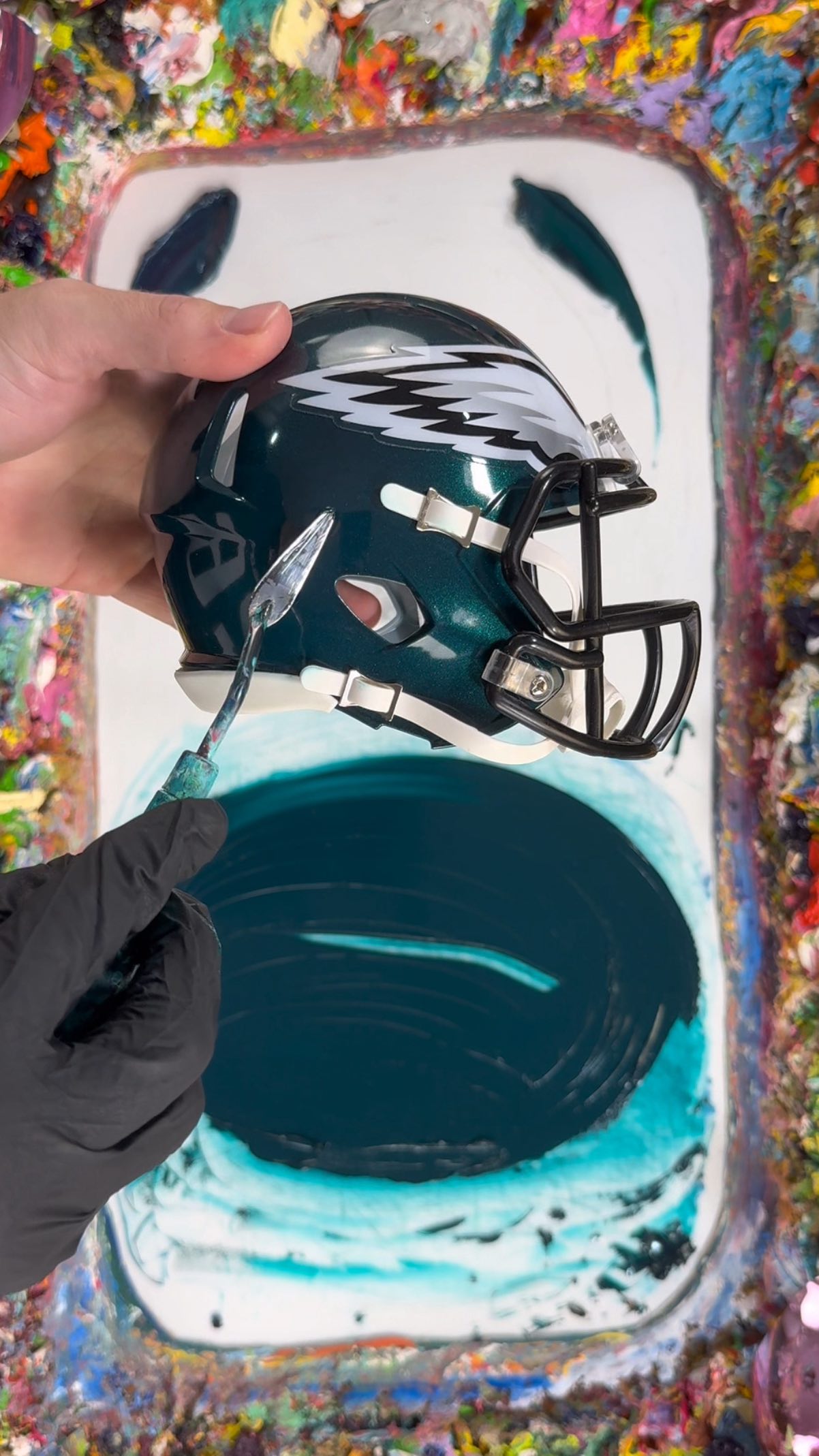 Instagram post by @fritzdoesart_ for Philadelphia Eagles. Caption reads: Color Matching the @philadelphiaeagles Helmet 🦅🎨.