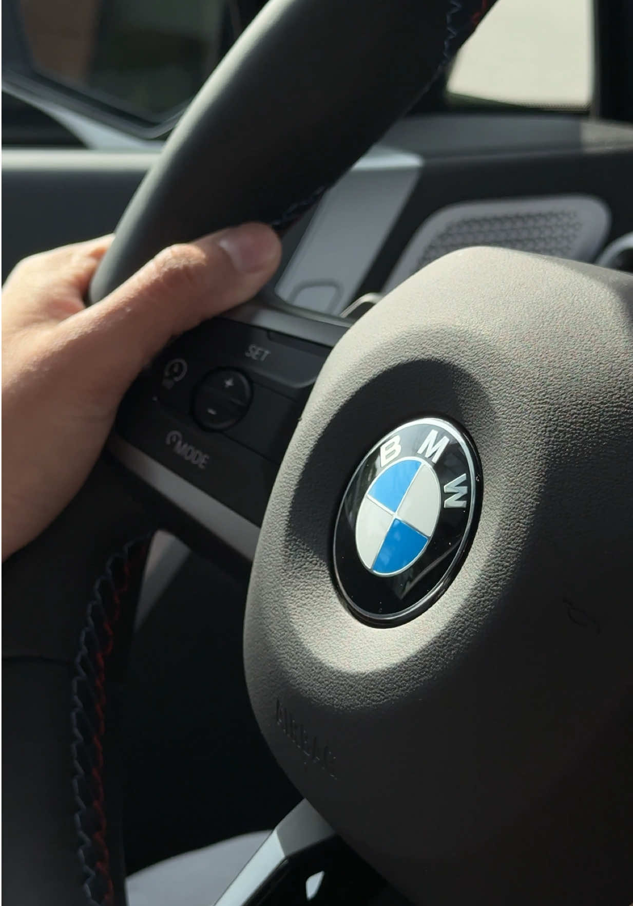 TikTok post by @just.jully for BMW USA. Caption reads: Umm BMW invited us to their HQ to test drive the....