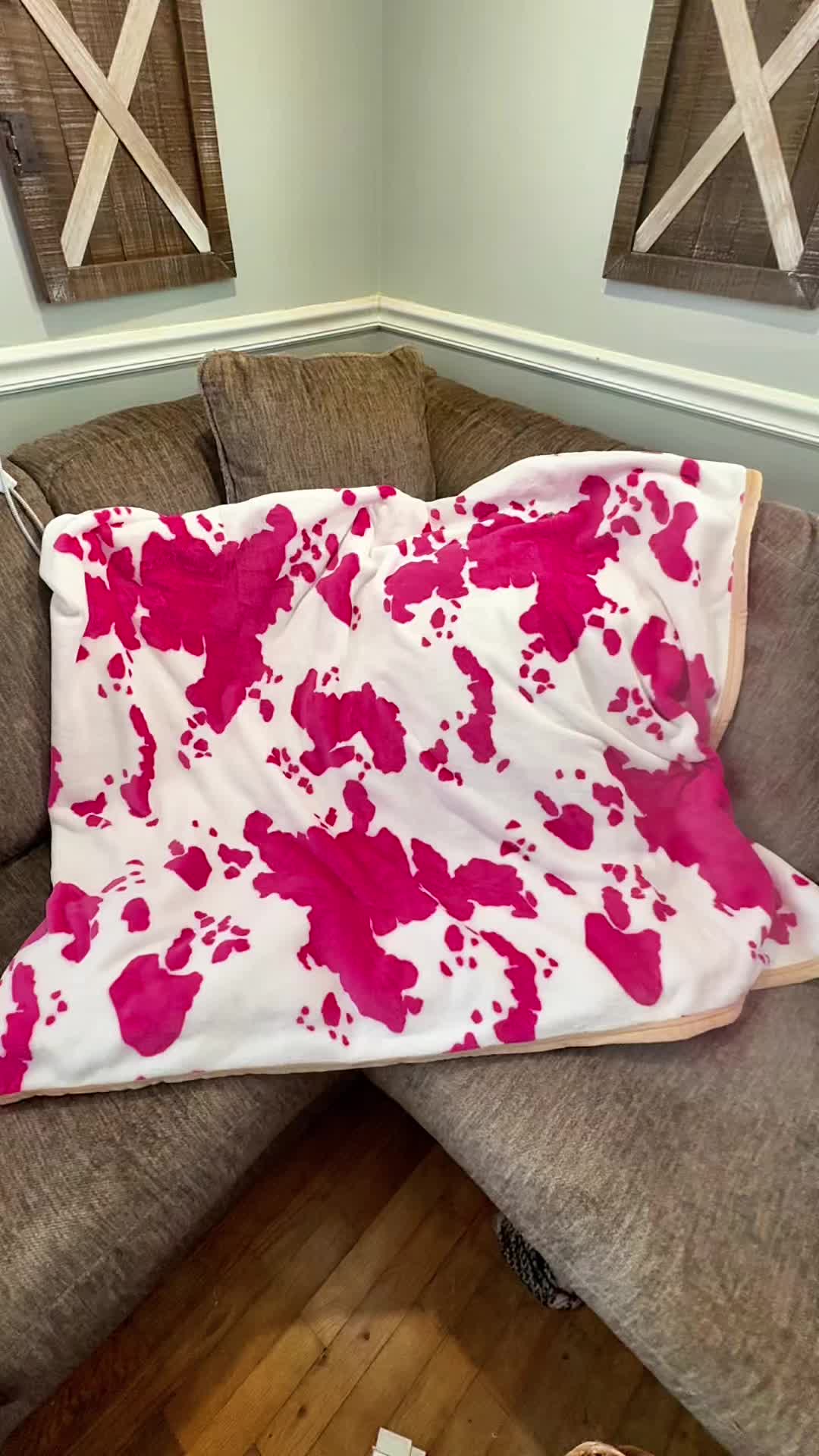 TikTok post by @staciejeanne_ for Dani Morgans. Caption reads: This cow print blanket completely changed the vibe....