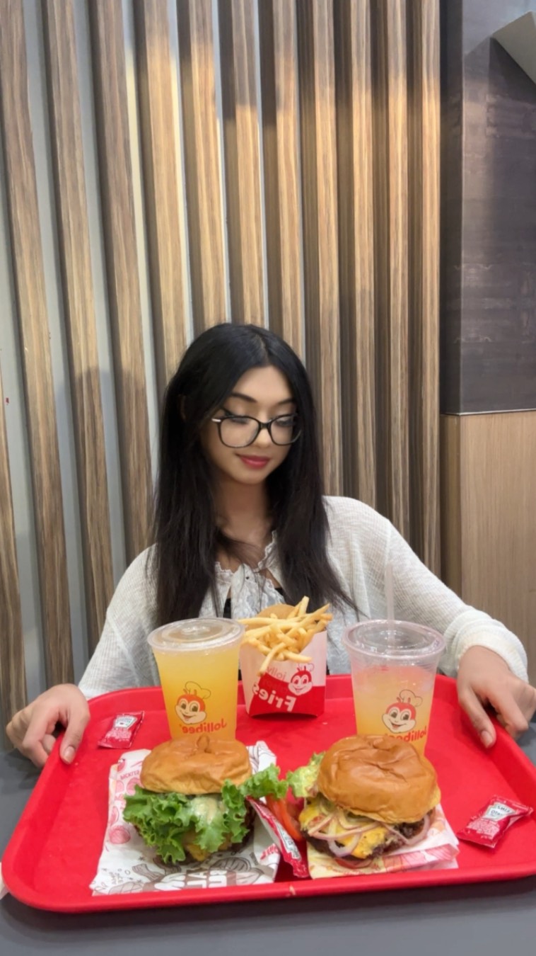 Instagram post by @feed_happiness_ for Jollibee US. Caption reads: Let’s try @jollibeeus new Angus Beef burgers....