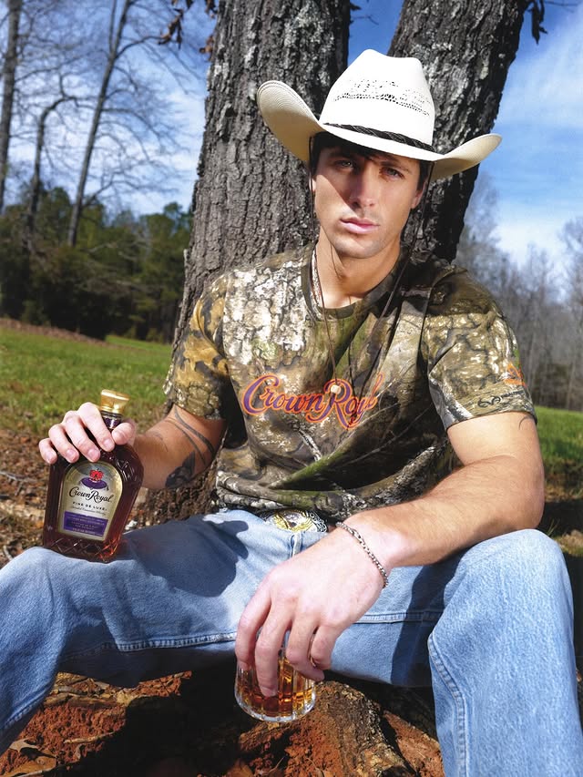 Instagram post by @robert_rausch for Crown Royal. Caption reads: Camo on my back, Crown in my glass 🥃 #ad....