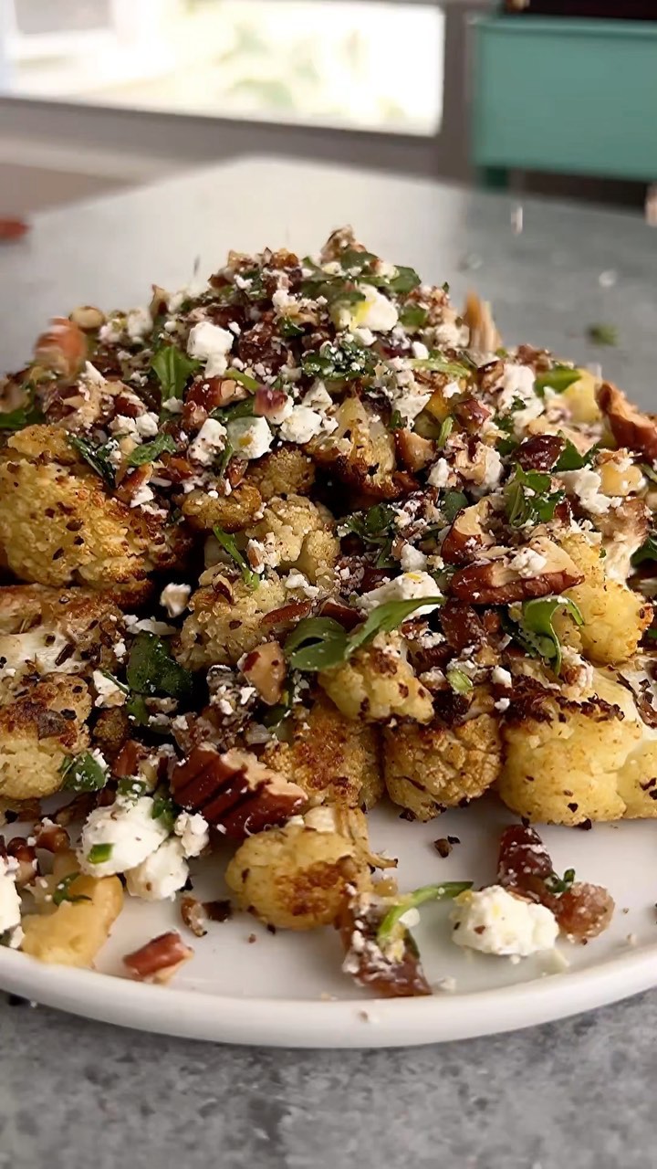 Instagram post by @starinfinitefood for The Kitchn. Caption reads: ROASTED CAULIFLOWER with PECAN, FETA & DATE....