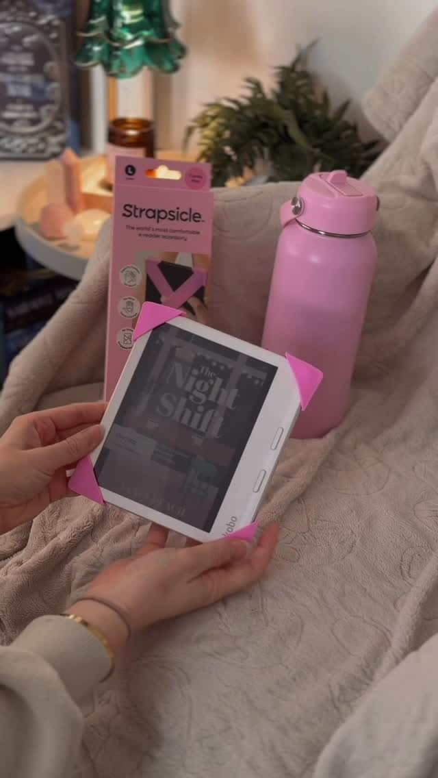 Instagram post by @erinsnextread for Strapsicle. Caption reads: Kindle grips are out and @strapsicle is in 😍💕....