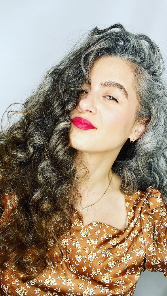 Instagram post by @silverstrandsofglitter for DERMA•E. Caption reads: #ad My hair is not the only thing I have been....