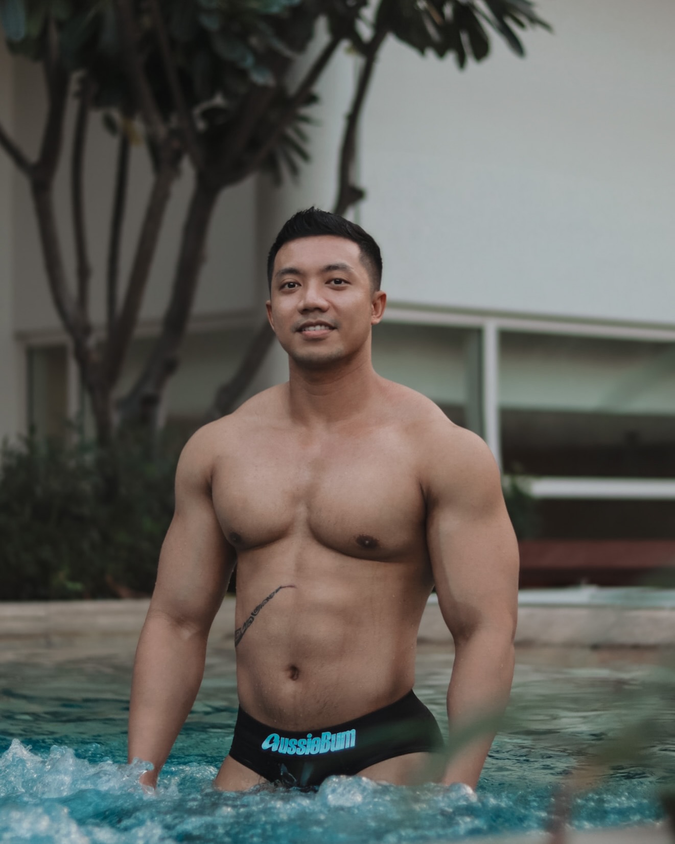 Instagram post by @rio.louxor for The Gay Passport. Caption reads: Pool chilling at @pullmanbangkokkingpower....