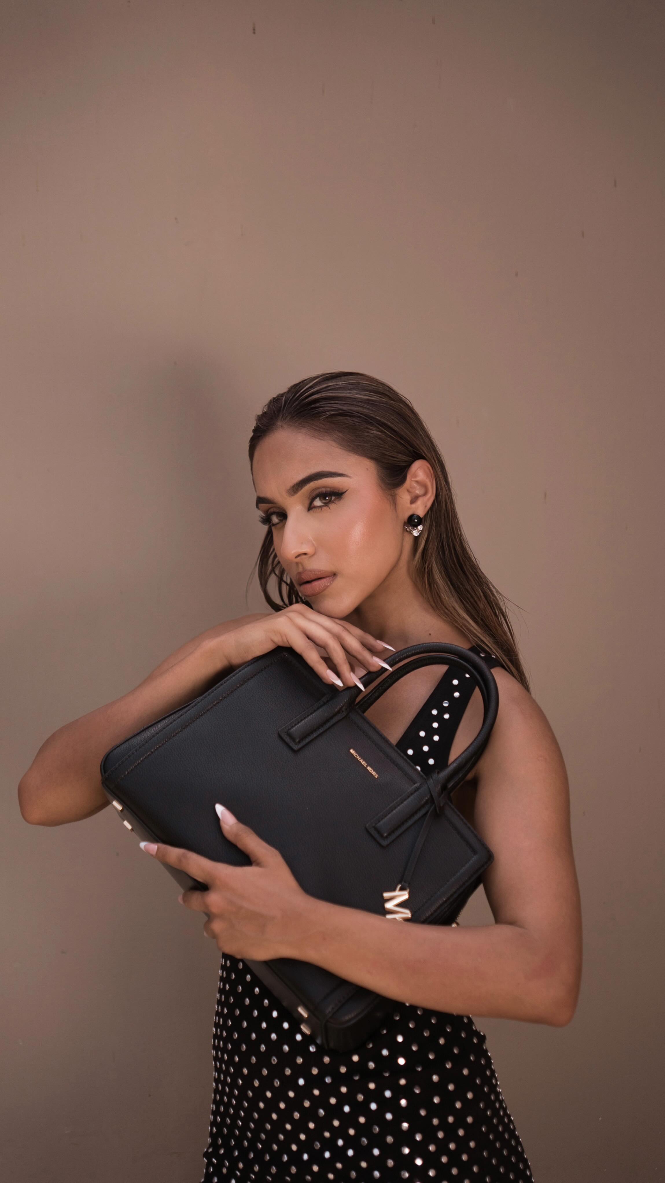 Instagram post by @gurleendahelay for Michael Kors. Caption reads: Golden hour glow and my @michaelkors plus one....