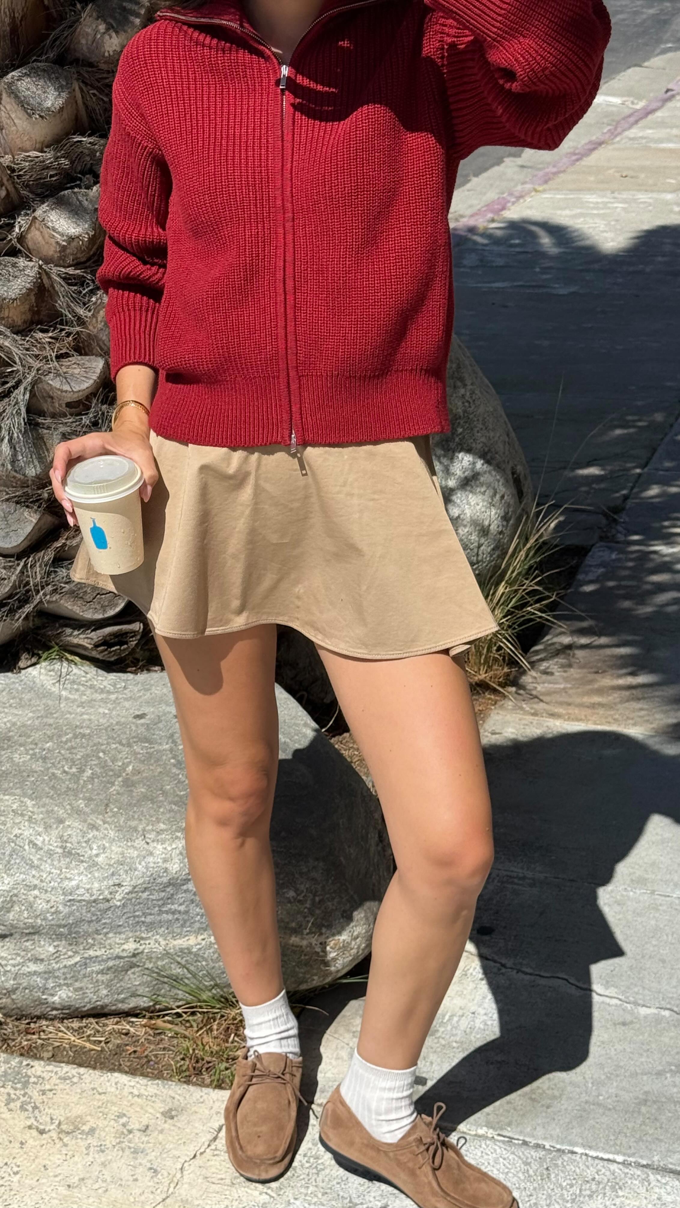 Instagram post by an influencer for EVERLANE. Caption reads: this skirt + sweater combo @everlane....