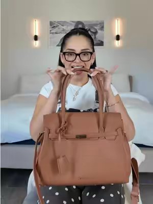 TikTok post by @dulce.rodriguezzz for Newbella Fashion. Caption reads: @Newbella.Fashion The perfect fall bag 🤎🍂 Love....