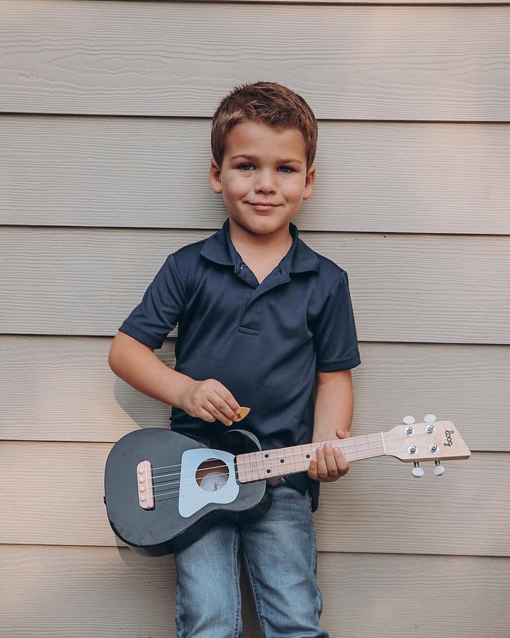 Instagram post by @mrs.britnyrobinson for Loog Guitars. Caption reads: [...] sure is enjoying his Ukulele from....