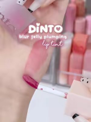 TikTok post by @withlovewoo for Dinto Cosmetics. Caption reads: [...] plumping lip tint ♡ @dinto_cosmetic @Dinto....