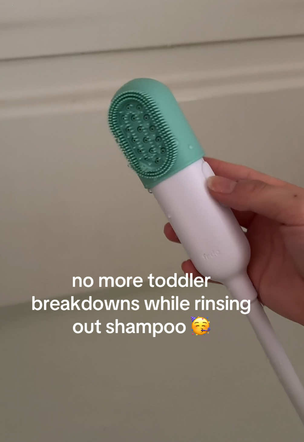 TikTok post by @reviewedbyleah for Fridababy. Caption reads: [...] my sanity at bathtime lol #bathsprayer....