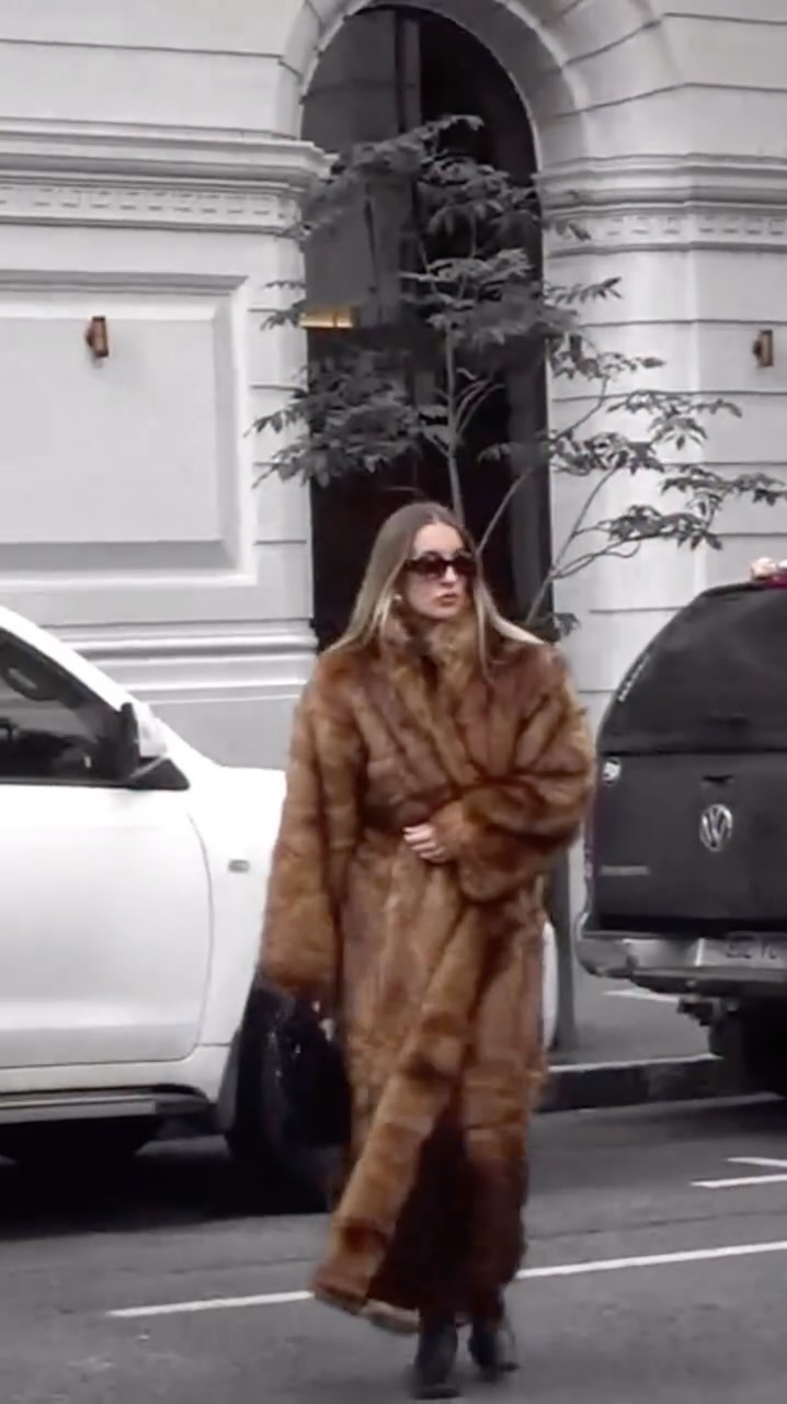 Instagram post by @dom.overseas for Khy. Caption reads: Errands in the city wearing the @khy faux fur maxi....
