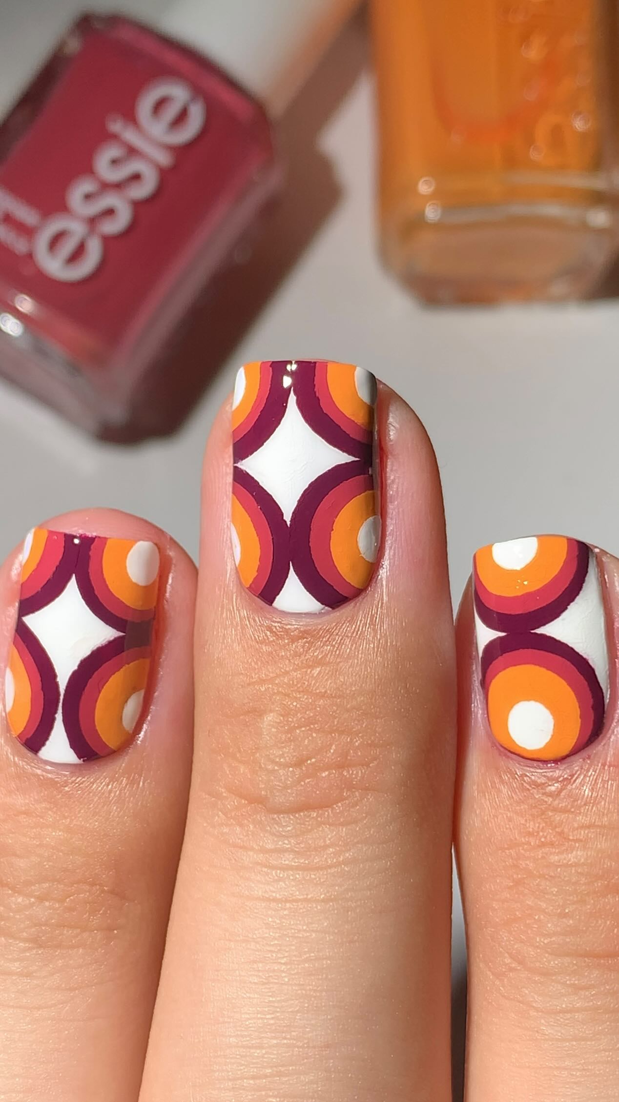 Instagram post by @abe.nailbabe for essie. Caption reads: ♥️What do you see?🤔👀Retro wallpaper chic?😅....