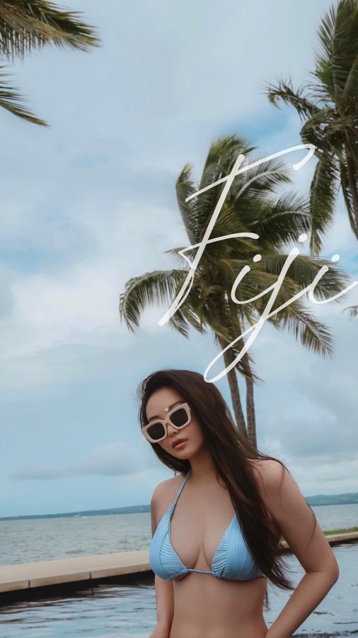 Instagram post by @viv_li for Hilton Hotels & Resorts. Caption reads: Fiji Getaway @hiltonfiji 🩵 This stunning resort....