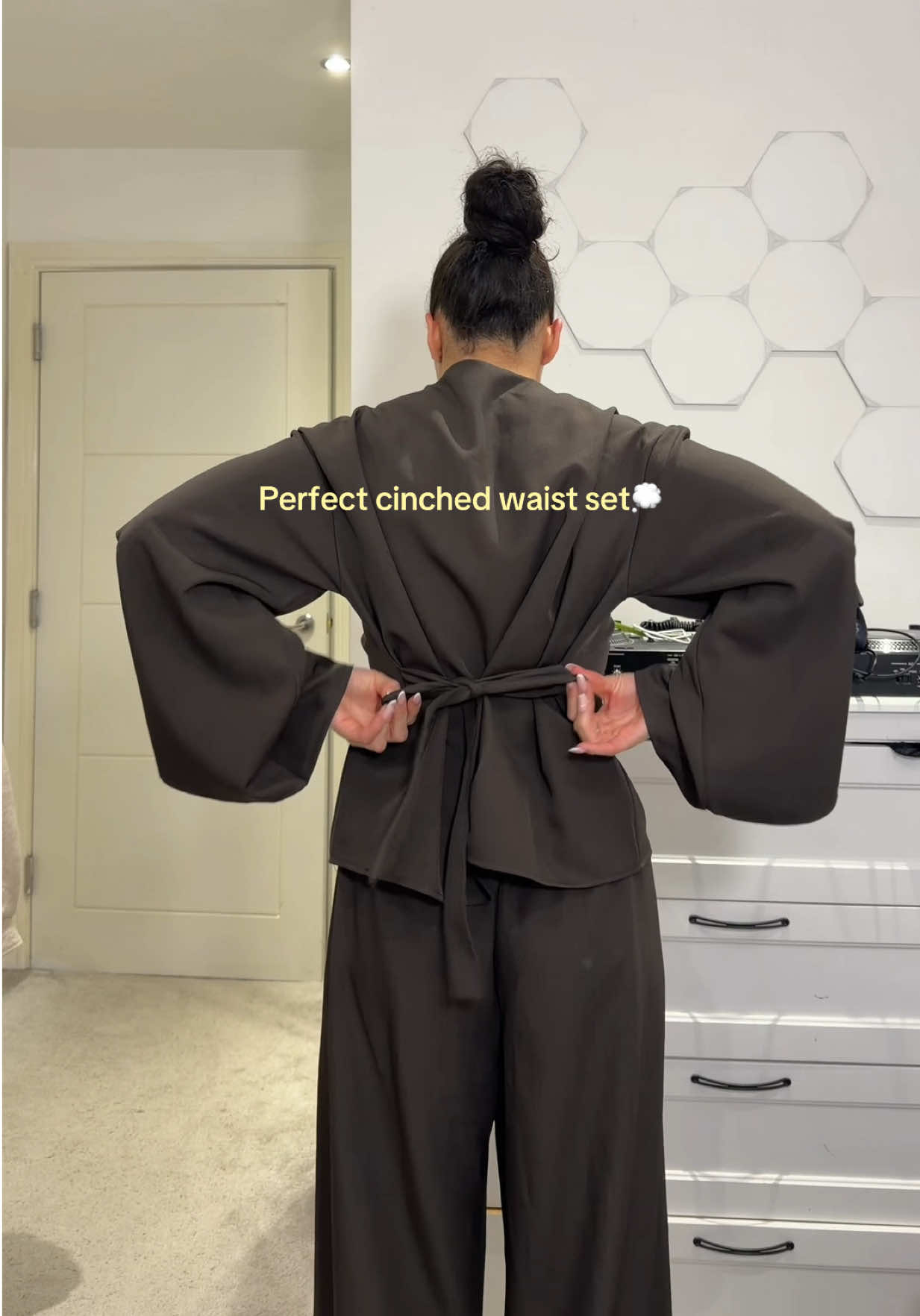 TikTok post by @tyrabaylis for emlavish. Caption reads: Sooo flattering with the bow detail💭 @emlavish....