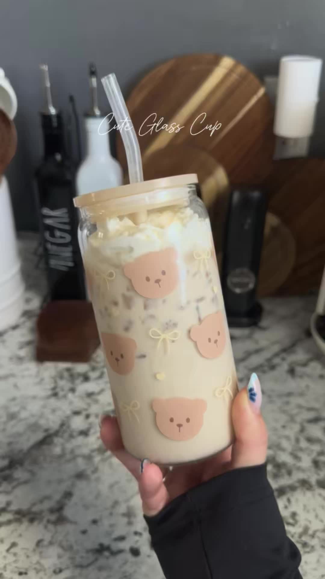 TikTok post by @wendyv.elly for Sandjest. Caption reads: [...] Glass Cup with Straw & Lid 🌸🎀🌷 ||....