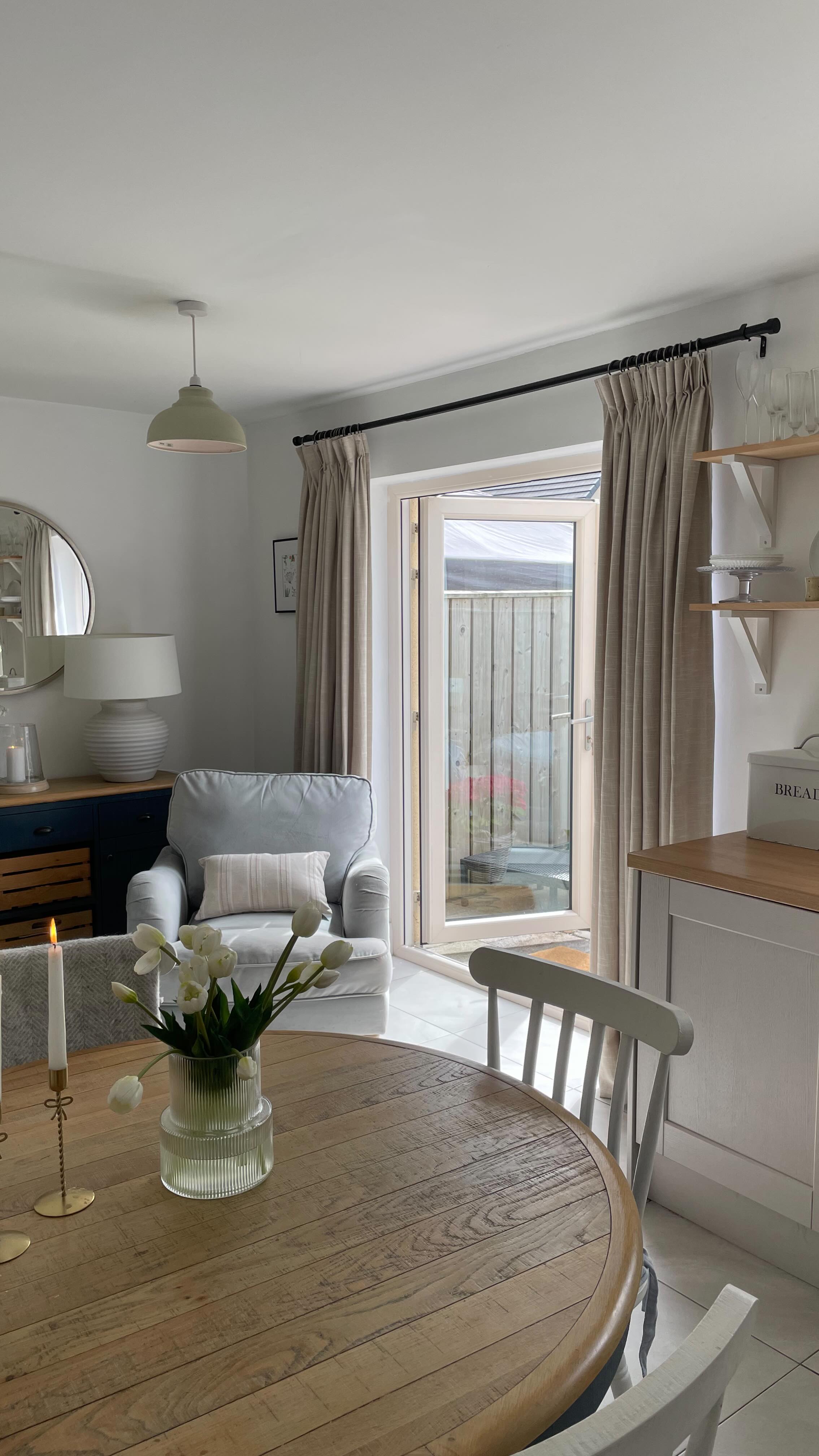 Instagram post by @laurensnihome for Twopagescurtains. Caption reads: Kitchen curtains: the secret to making your space....